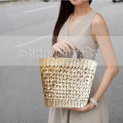 Stylish handwoven water hyacinth open weave handbag with wooden top handle.