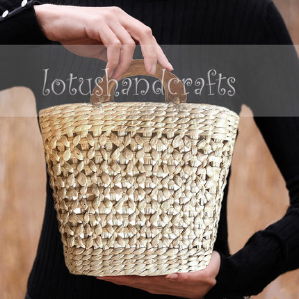 Handwoven water hyacinth open weave handbag with a unique wooden top handle.