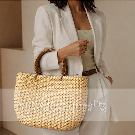Handwoven water hyacinth tote bag with round rattan handles for a youthful look.