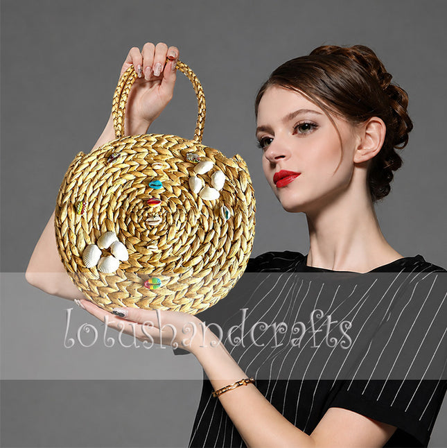 Boho round water hyacinth tote with seashell embellishments.