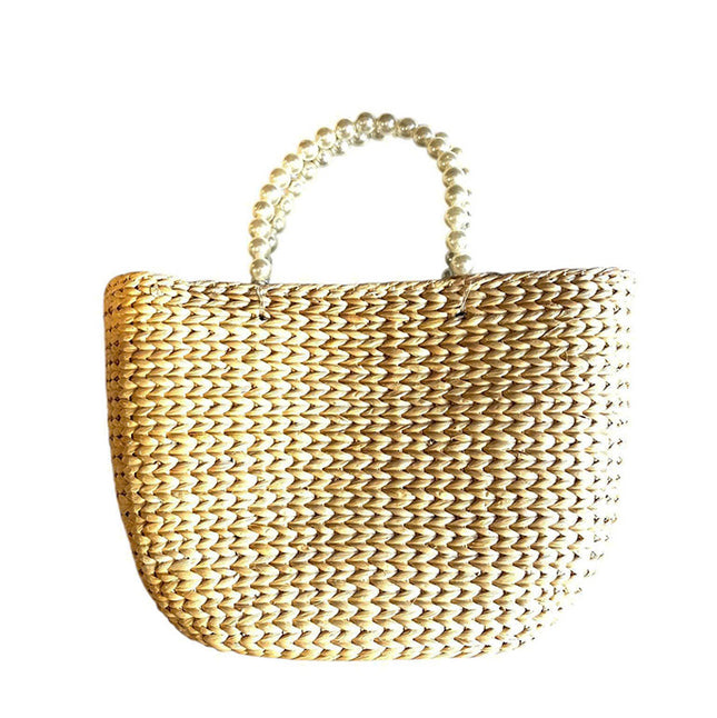 Handwoven water hyacinth tote bag with elegant pearl handles.