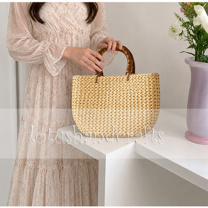 Handwoven water hyacinth tote bag with round rattan handles for a stylish look.
