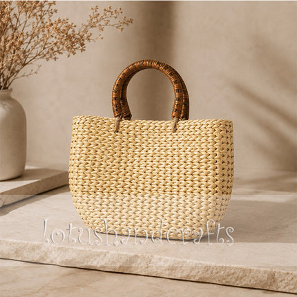 Handwoven water hyacinth tote bag with round rattan handles.