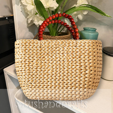 Handwoven water hyacinth tote bag with wooden bead handles for everyday style.