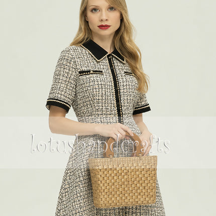 Handwoven water hyacinth handbag with a modern wooden top handle.