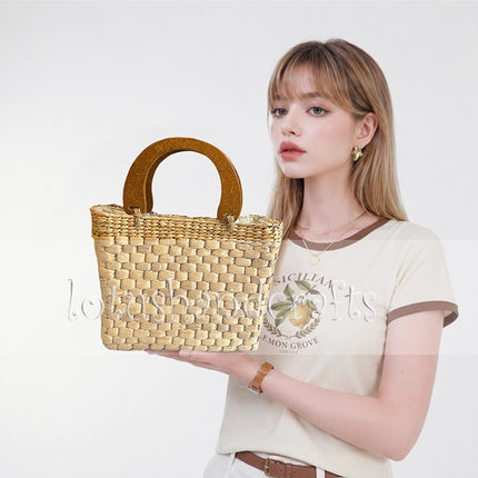 Handwoven water hyacinth handbag with a stylish wooden top handle.