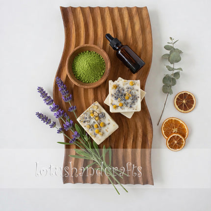 Handcrafted wave carved wooden serving board styled in a warm and minimal flatlay setting.