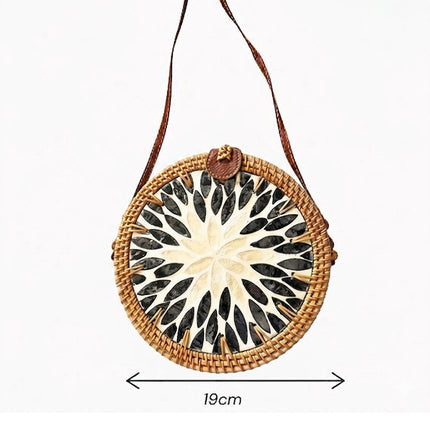 Round woven rattan crossbody purse with mother of pearl details and boho style size.