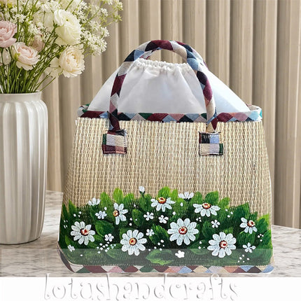 Handwoven seagrass tote bag with hand painted wild daisy meadow floral design.