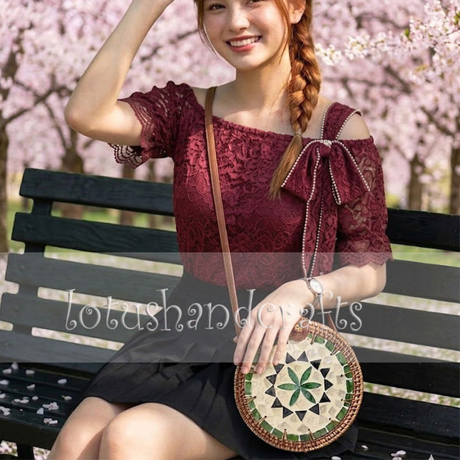 Unique womens round rattan crossbody bag with mother of pearl and green flower mosaic accents.