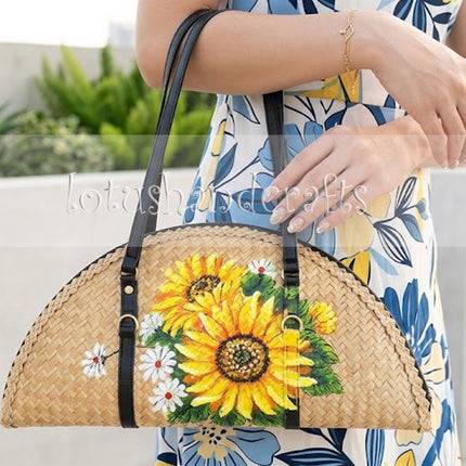 This woven grass half moon bag with sunflowers is highly durable for your everyday use.
